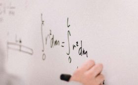 Person writing Math problems on white board